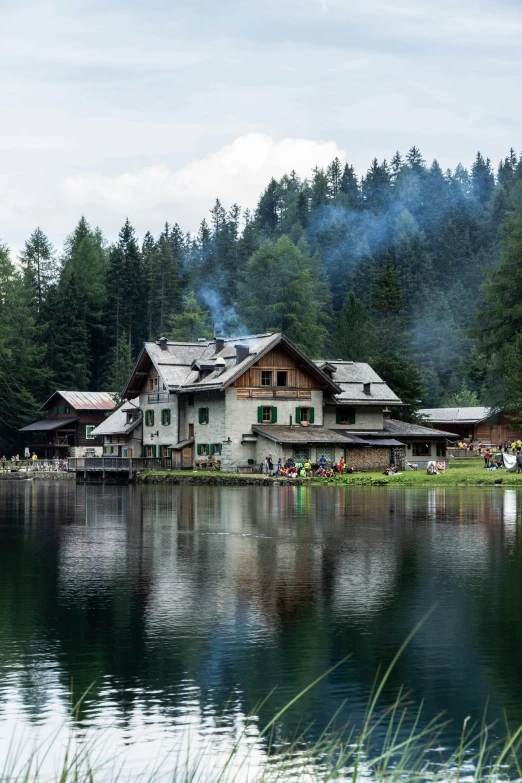 a large building on the lake with people in the water