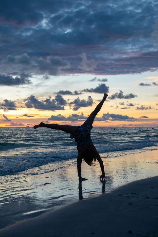 a person standing on their hand doing a handstand