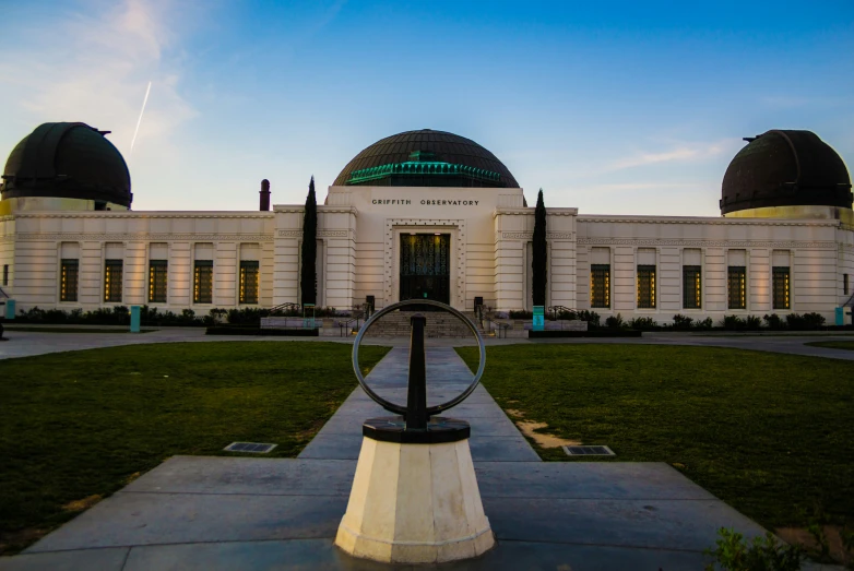 a large white building with two domes around it