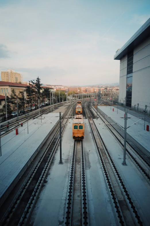 train tracks in front of buildings with snow