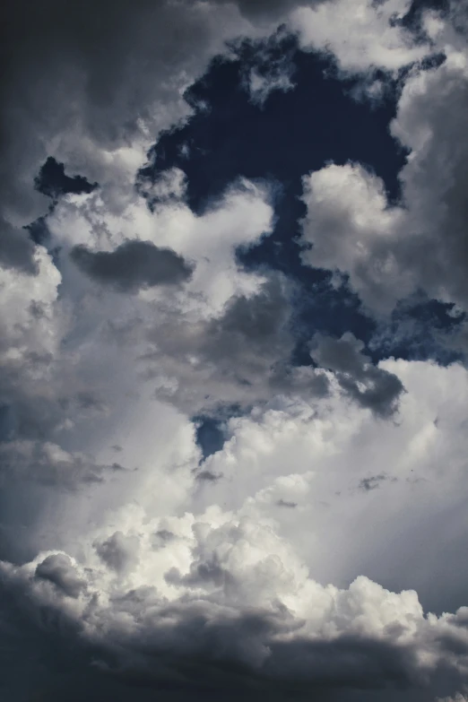 an airplane flying through the sky with clouds