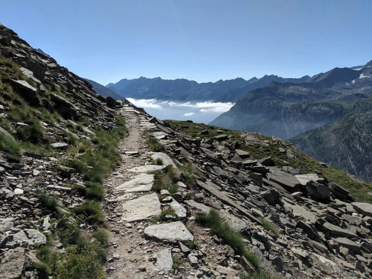 a path leads up the side of a mountain in the mountains