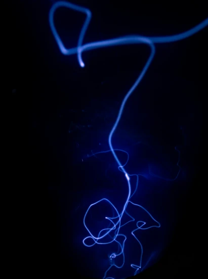 a glowing blue wire in the dark