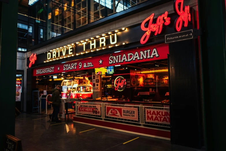 a pizza restaurant is lit up at night