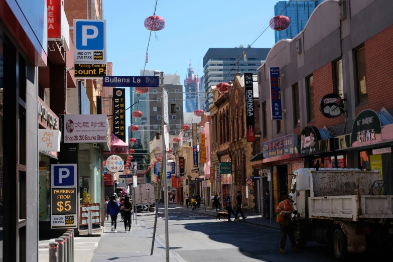 a street with shops, restaurants and people walking