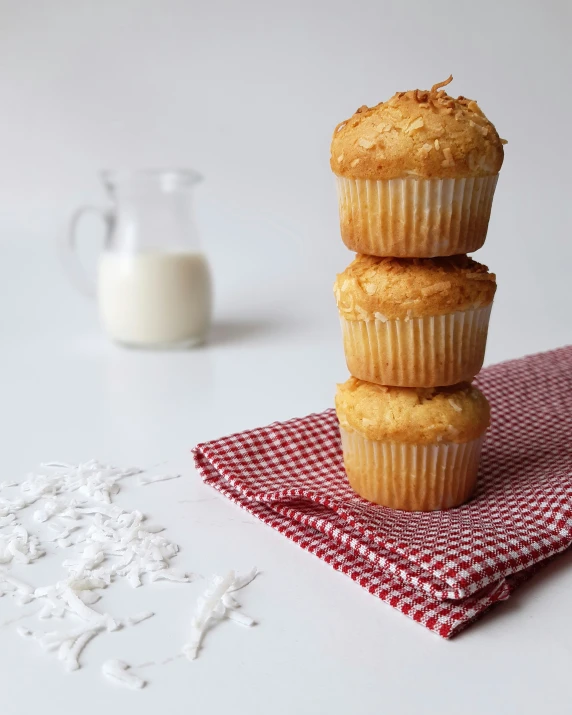 three pastries are sitting on a napkin next to a glass bottle