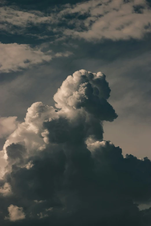 a jet flying up into the sky with storm clouds