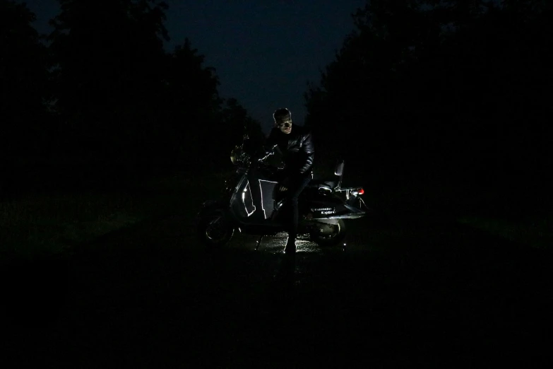 motorcycle in the dark on the side of a road