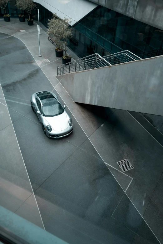 an automobile on the side of a street near a building