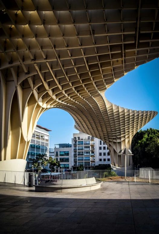 an arch over looking a city with buildings