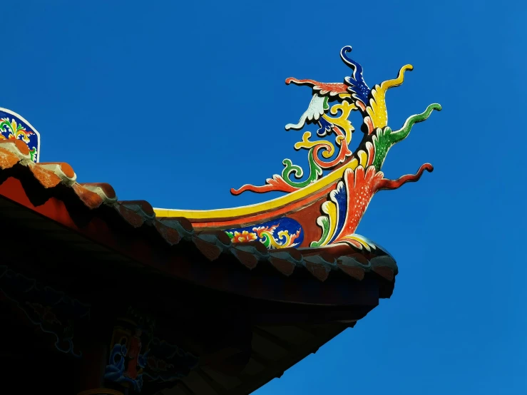 a colorful dragon decoration atop a roof