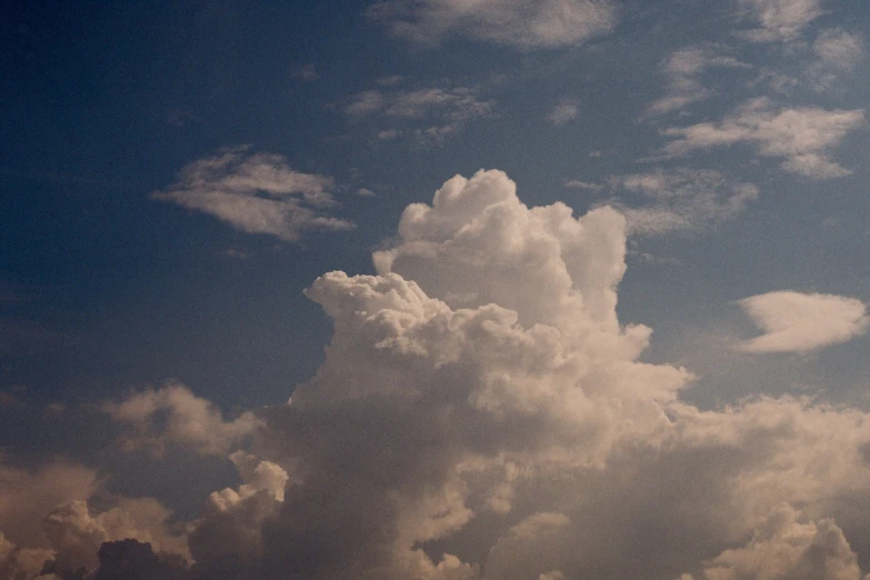 the sky is partly cloudy and a plane can be seen in the distance