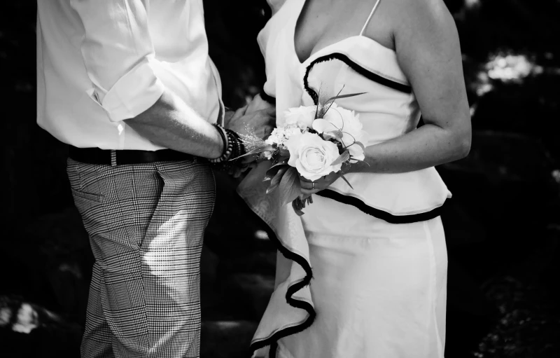 a black and white image of two people getting married