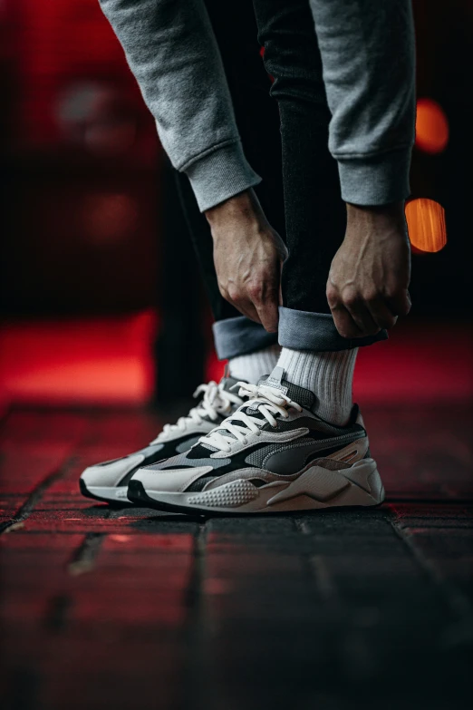 a close - up of the foot and ankle of a person wearing a pair of sneakers