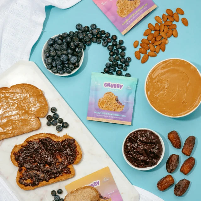 almonds, raisins, and peanut er spread out to make jelly sandwiches