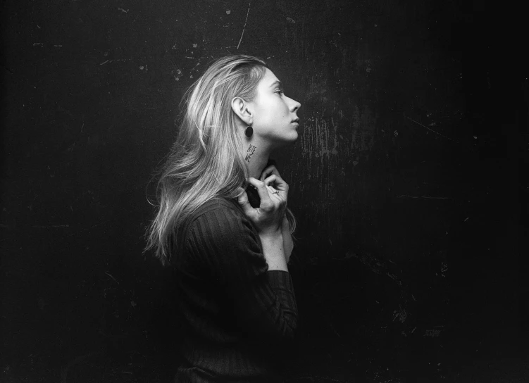 a black and white po of a woman wearing earrings