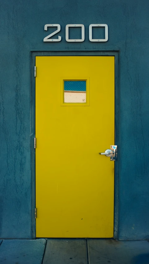 a yellow door to a blue building is open