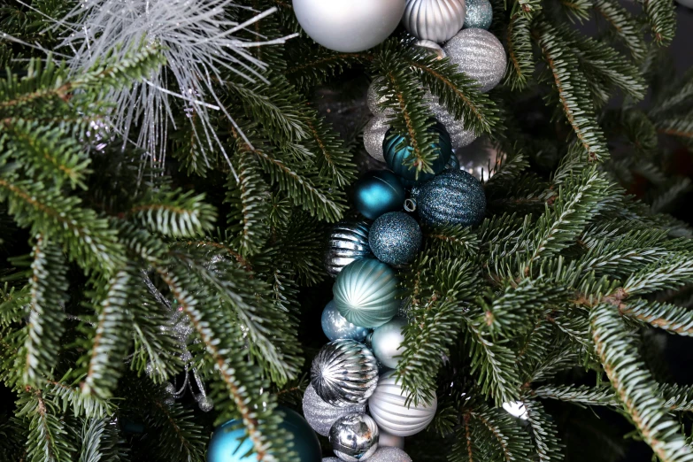 a close up of several ornaments on a christmas tree