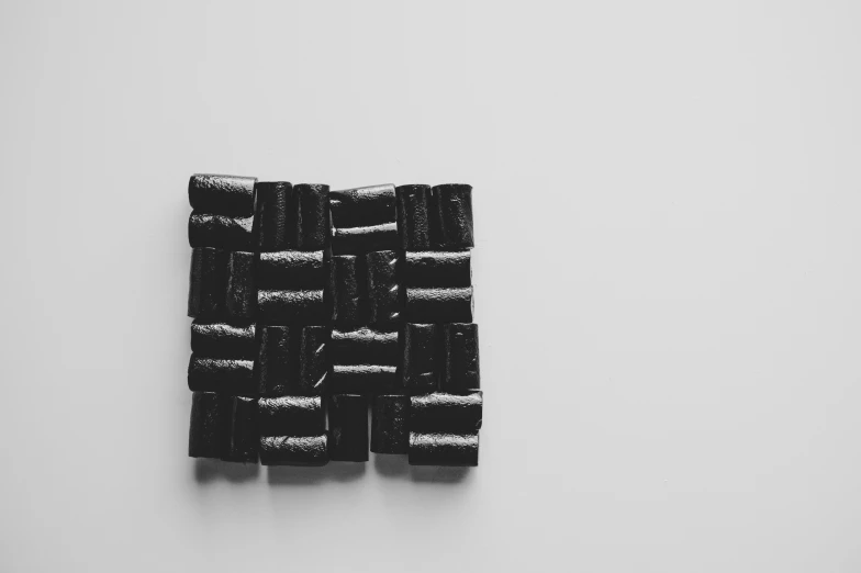 four pieces of black ribbon hanging from a wall