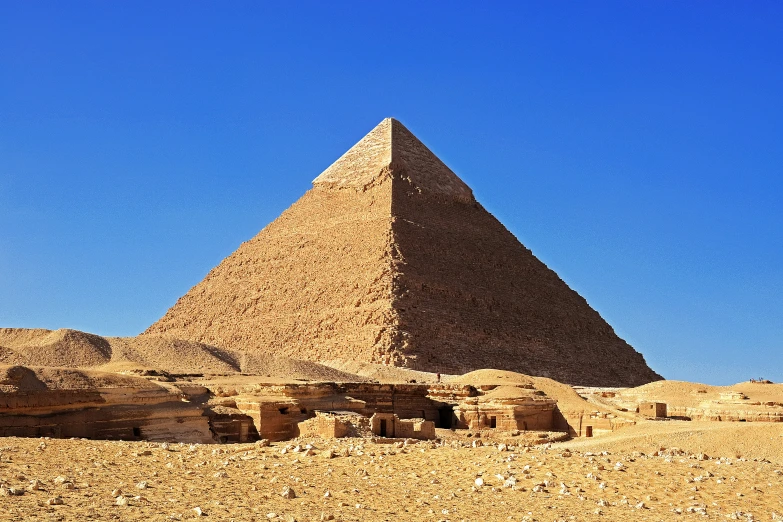 some people stand at the base of a tall pyramid