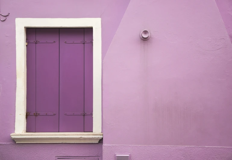 the wall with an open window is painted purple