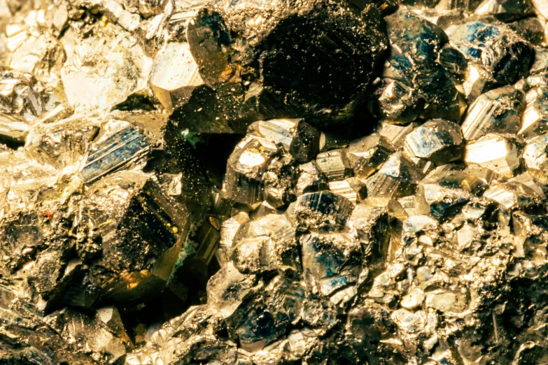 a rock surface has many rocks with different small blue chunks