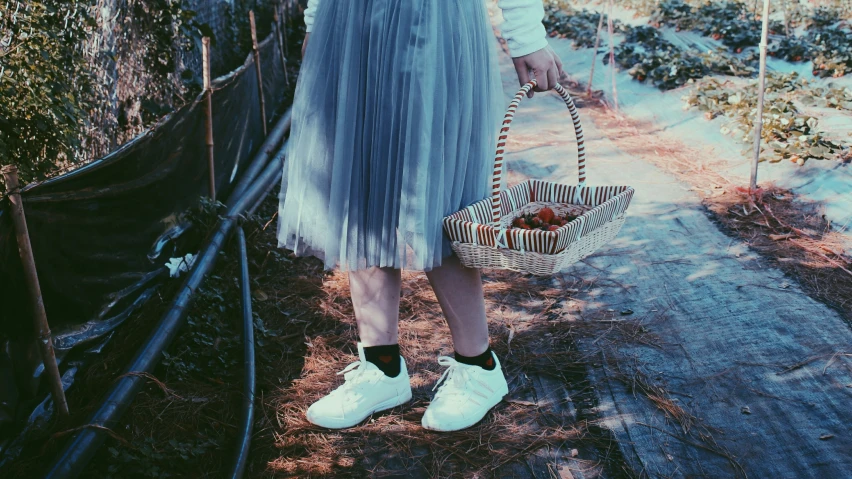 a woman holding a basket full of fruit