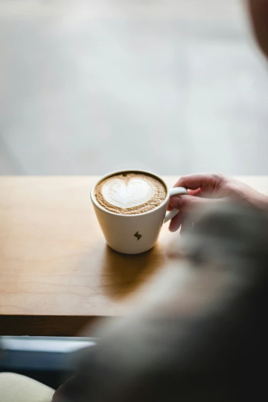 person holding a cup with some type of drink in it