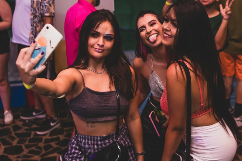 two women taking a selfie with their phone