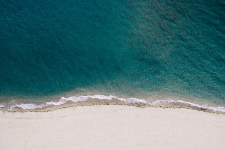 the beach has waves coming in from the water