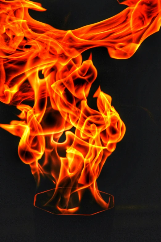 fire burning on a dark black background, with bright colors