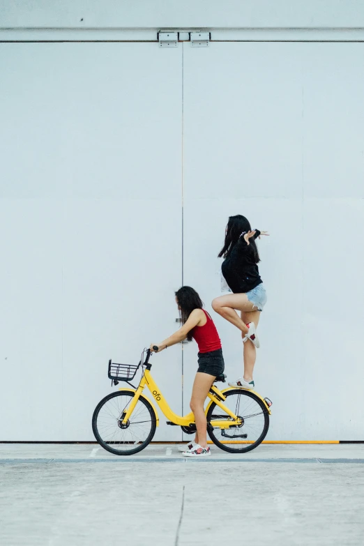 there is a woman riding a yellow bike