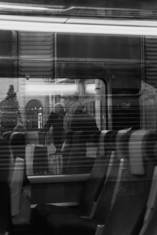 people riding on a train in black and white