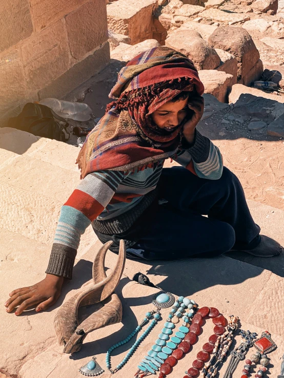 an image of a woman sitting on the ground