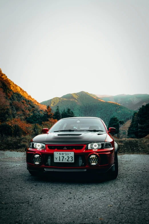 a car sitting in the middle of a mountain road