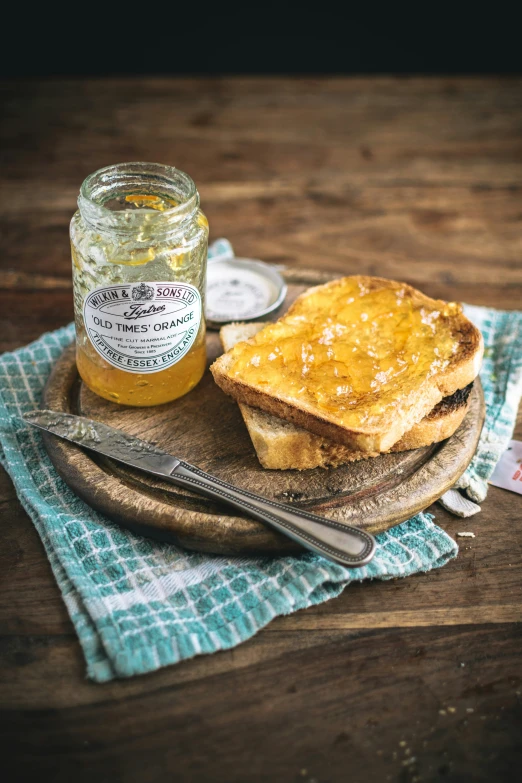 a toast with er on top of it and a jar of jam