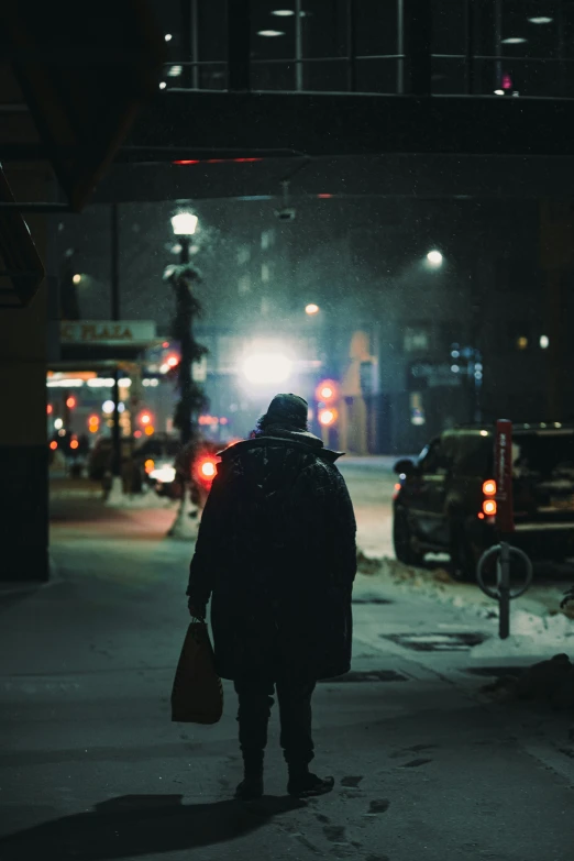 a man walking in the dark with a bag on his back