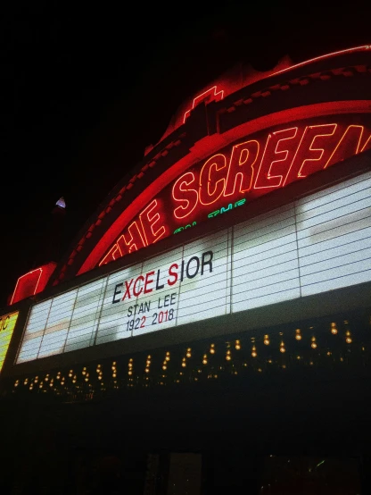 a large marquee with the words the screen lit up in front of it