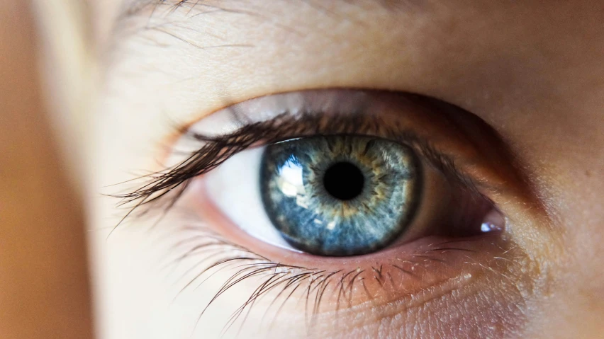 a person with a very blue eye stares at the camera