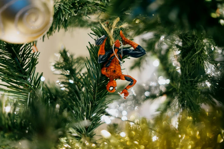 an ornament hanging from a pine tree on a christmas tree