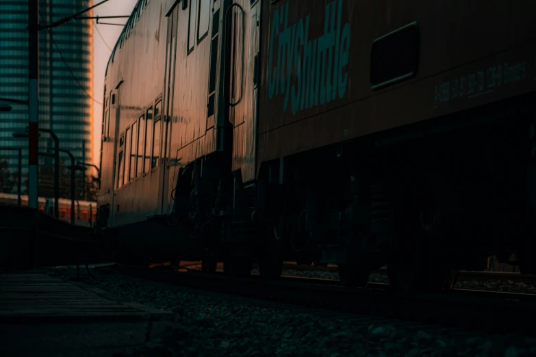 a train engine with a car going down the tracks