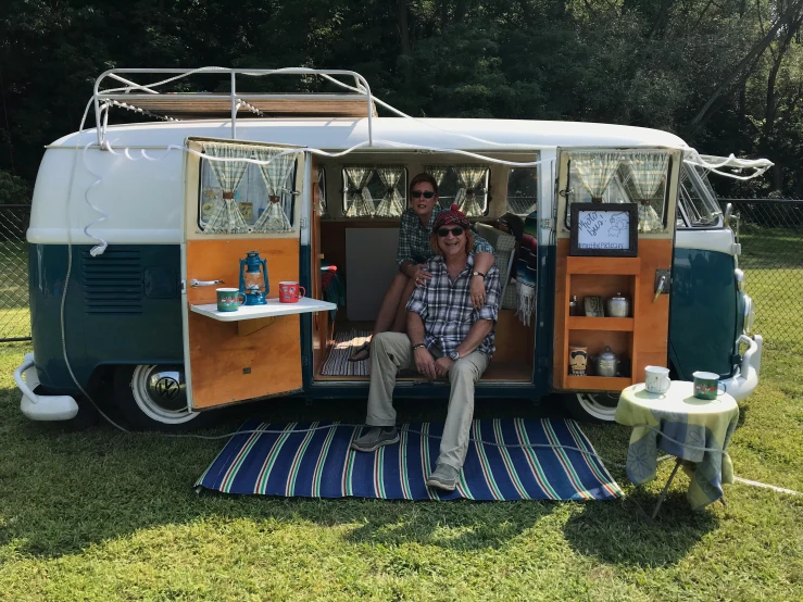 a man sits inside the van while eating food