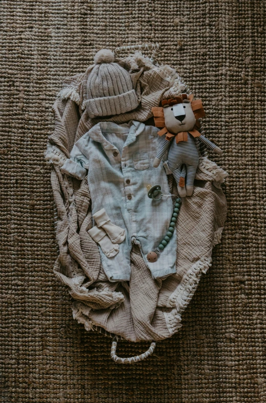 a stuffed animal sits next to a shirt and a sock