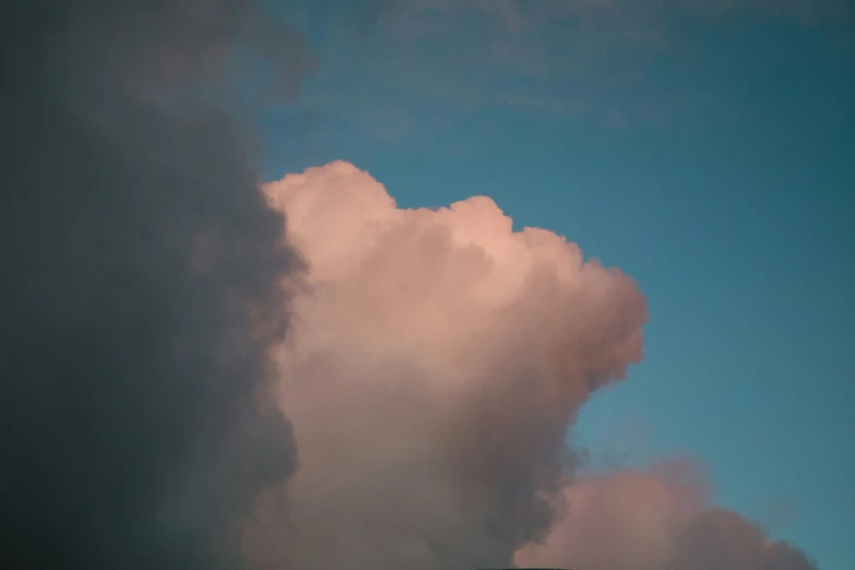 a tall cloud appears to be rising in the sky