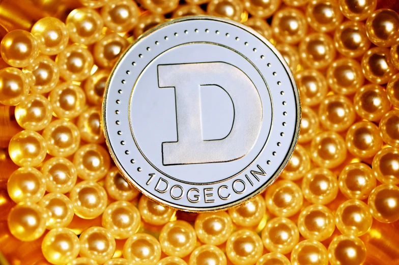 a close up image of the d logo on a coin surrounded by gold balls
