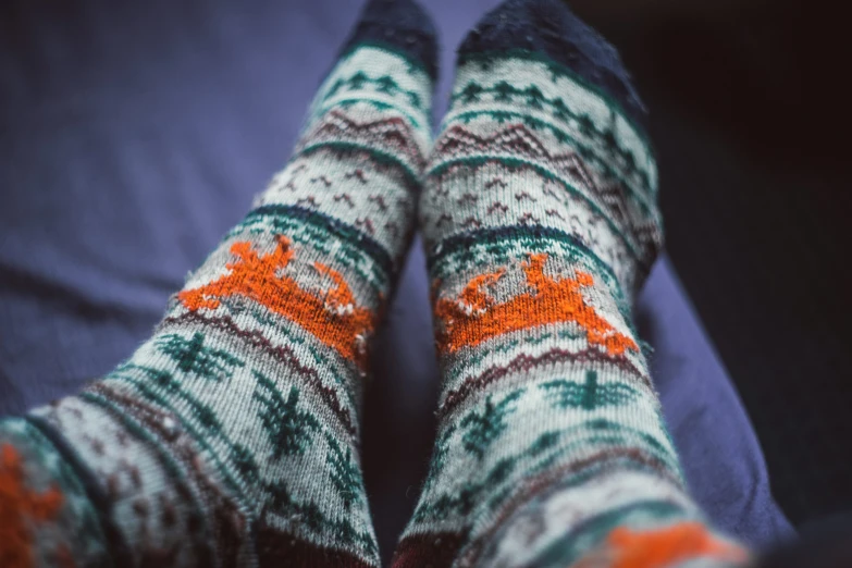 the bottom of someones feet wearing colorful socks