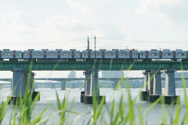 a train is moving on the tracks over water