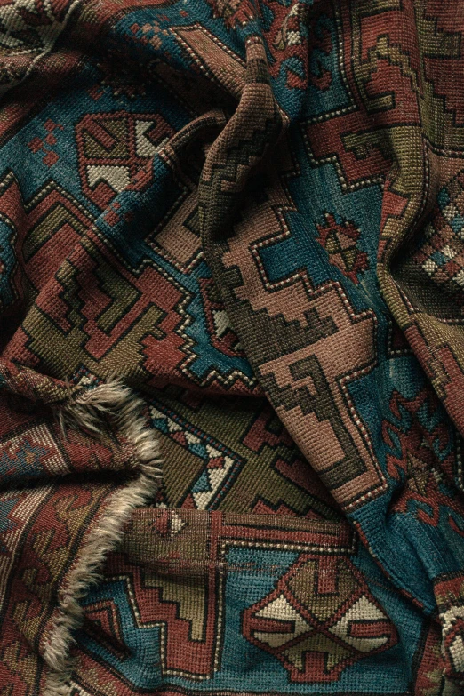 close up view of a multi - colored afghan rug