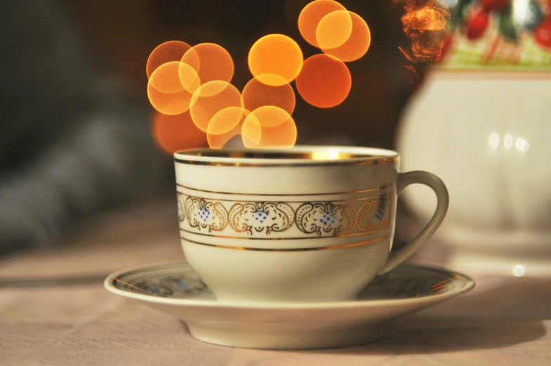 a cup is sitting on a saucer with blurry images