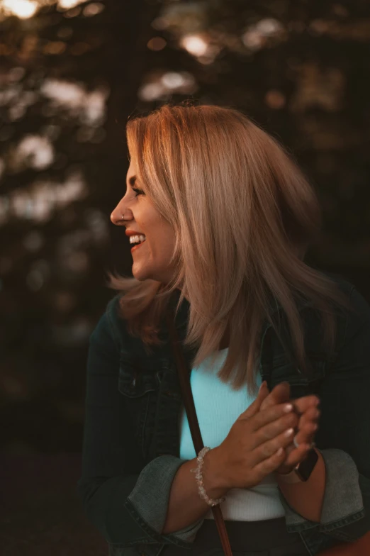 a women who is smiling and holding a umbrella